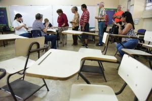 Puerto Rico residents line up to vote during the U.S. territory's Democratic primary election at the Luis Llorens Torres Elementary School in San Juan, Puerto Rico, Sunday June 5, 2016. Puerto Ricans frustrated by island's economic crisis are voting in the U.S. territory's Democratic presidential primary, as front-runner Hillary Clinton draws closer to securing the number of delegates needed to win her party's nomination. (AP Photo/Carlos Giusti)
