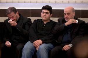 Ali Badreddine, center, son of top Hezbollah commander Mustafa Badreddine, mourns as  he receives condolences in a southern suburb of Beirut, Lebanon, Friday, May 13, 2016. Lebanon's militant Hezbollah group said Friday that its top military commander who was supervising its military operations in Syria, Mustafa Badreddine, was killed in an explosion in Damascus, a major blow to the Shiite group which has played a significant role in the conflict next door. (AP Photo/Hassan Ammar)