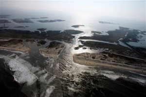 FILE - This Sunday, Aug. 28, 2011 file photo shows a flooded road on Hatteras Island, N.C., after Hurricane Irene swept through the area the previous day cutting the roadway in five locations. How high will water really get during a storm? A pilot program uses data from the U.S. Geological Survey and NOAA to try to answer this key question for coastal residents and visitors. The model takes into account data thats already available on storm surge and tides and combines it with information on wave run-up, or how big waves will get. (AP Photo/Jim R. Bounds)