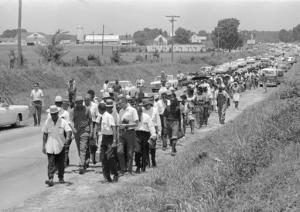 FILE - In this June 9, 1966 file photo, civil rights activists led by Dr. Martin Luther King stretch out along Highway 51 south near Senatobia, Miss., on a march to the capital, Jackson, started by James Meredith. The March Against Fear helped many find a voice to protest the injustices of the day. (AP Photo)