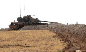 A Turkish tank is stationed near the Syrian border, in Karkamis, Turkey, Monday, Aug. 29, 2016. Turkey's state-run news agency says three rockets fired from Syria have hit Turkish border town of Kilis, injuring five children, Turkish President Recep Tayyip Erdogan says Turkey will press ahead with its military operations in Syria until the Islamic State group and Kurdish militants no longer pose a security threat. Erdogan said Turkey was determined to take all steps necessary both inside Turkey and abroad to protect Turkish citizens.(Ismail Coskun/IHA via AP)