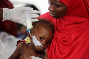 A doctor feeds a malnourished child at a feeding centre run by Doctors Without Borders in Maiduguri Nigeria, Monday Aug. 29, 2016. Children who escaped Boko Haram's Islamic insurgency now are dying of starvation in refugee camps in northeastern Nigeria's largest city as the government investigates the theft of food aid by officials. ( AP Photo/Sunday Alamba)