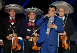 FILE - In this April 28, 2016, file photo, Mexican singer Juan Gabriel performs during the Latin Billboard Awards in Coral Gables, Fla. Representatives of Juan Gabriel have reported Sunday, Aug. 28, 2016, that he has died. Gabriel was Mexico's leading singer-songwriter and top-selling artist with sales of more than 100 million albums. The statement says he died Sunday, but did not say where. (AP Photo/Wilfredo Lee, File)