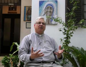 Rev. Brian Kolodiejchuk, postulator of the cause of beatification and canonization of Mother Teresa, is interviewed by the Associated Press in front of a mosaic picturing Mother Teresa, at the formation house of the priestly branch of the Missionaries of Charity on the outskirts of Rome, Friday, Aug. 18, 2016. When Pope Francis canonizes Mother Teresa on Sunday, Sept. 4, 2016, he'll be honoring a nun who won admirers around the world and a Nobel Peace Prize for her joy-filled dedication to the "poorest of the poor." (AP Photo/Giulia Sabella)