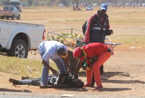 A suspected protestor lies on the ground unconscious after a confrontation with Zimbabwean Riot Police during a demonstration in Harare, Friday, Aug., 26, 2016. The demonstration organised by opposition political parties calling for reforms is the first time that the fractured opposition has joined forces in a single unified action to confront President Robert Mugabes government.(AP Photo/Tsvangirayi Mukwazhi)