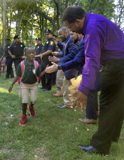 Black professionals cheer on city students starting&nbsp;school
