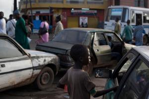 FILE-In this file photo Sept. 24, 2013 photo, a "talibe" begs for change from a driver stopped at a gas station, in the Medina Gounass suburb of Dakar, Senegal. More than 500 such children have been taken from Dakar's streets in the past two months. President Macky Sall announced the crackdown in June, 2016, and said the government will prosecute, fine and jail parents or Quranic teachers, known as marabouts, who are found guilty of abuses.( AP Photo/Rebecca Blackwell,File)