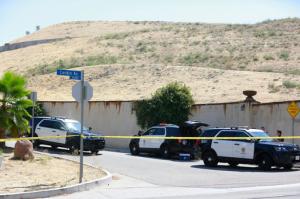 Los Angeles Police patrol the entrance to the street of singer Chris Brown's home in the Tarzana neighborhood of Los Angeles, Tuesday, Aug. 30, 2016. Authorities are waiting for a search warrant for his house after a getting a woman’s call for help, officials said. Inside, the entertainer, who has a history of legal problems, posted videos to social media declaring his innocence. (AP Photo/Damian Dovarganes)