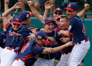FILE- In this Aug. 28, 2016, file photo, Endwell, N.Y., pitcher Ryan Harlost, center, celebrates with teammates after getting the final out of the Little League World Series Championship baseball game against South Korea in South Williamsport, Pa. New York Gov. Andrew Cuomo announced that the Maine-Endwell Little League team will be honored with a special ceremony at the New York State Fair on Thursday, Sept. 1. The Maine-Endwell team is the first New York team to win the Little League World Series since 1964. (AP Photo/Gene J. Puskar, File)