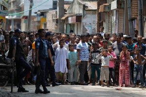 Bangladeshis gather near a shooting scene in Narayanganj, outskirts of Dhaka, Saturday, Aug. 27, 2016. Police in Bangladesh say they have killed three suspected militants, including Tamim Chowdhury, a Bangladeshi-born Canadian, who police believe was one of two masterminds of the attack on a popular restaurant in Dhaka. (AP Photo)