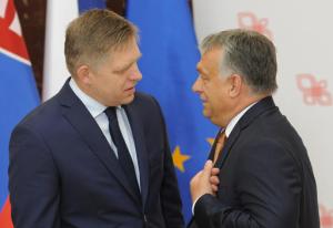 Prime Ministers of Slovakia, Robert Fico, left, and Hungary, Viktor Orban, talk prior to a meeting with German Chancellor Angela Merkel in Warsaw, Poland, Friday, Aug. 26, 2016. Merkel came to Warsaw for talks with four central European leaders about the shape of the European Union after Britain leaves and about migrants, ahead of an EU summit planned next month. (AP Photo/Alik Keplicz)