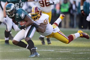 FILE - In this Sunday, Dec. 23, 2012 file photo, Philadelphia Eagles' Jeremy Maclin, left, is tackled by Washington Redskins' Perry Riley in the first half of an NFL football game in Philadelphia. The Washington Redskins released four-year starting linebacker Perry Riley and defensive lineman Stephen Paea as they continued to cut down to their 53-man roster, Tuesday, Aug. 30, 2016. (AP Photo/Mel Evans, File)