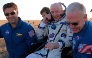 U.S. ground personnel carry U.S. NASA astronaut Jeff Williams  after landing in a remote area near the town of Zhezkazgan, Kazakhstan, Wednesday, Sept. 7, 2016. The record-setting American and two Russians landed safely back on Earth Wednesday after a six-month mission aboard the International Space Station. (Maxim Shipenkov/Pool Photo via AP)