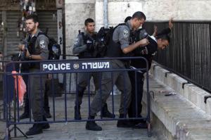 Israeli border police officers search a Palestinian man near the scene of a stabbing attack in Jerusalem's old city, Monday, Sept. 19, 2016. A Palestinian assailant stabbed two police officers outside Jerusalem's Old City early on Monday and was shot, police said, following a bloody weekend that shattered weeks of relative calm. (AP Photo/Mahmoud Illean)