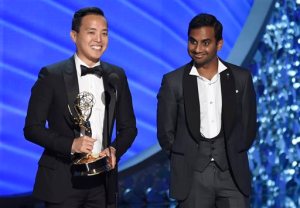 Kelvin Yu, left, and Aziz Ansari accept the award for outstanding writing for a comedy series for Master of None at the 68th Primetime Emmy Awards on Sunday, Sept. 18, 2016, at the Microsoft Theater in Los Angeles. (Photo by Chris Pizzello/Invision/AP)