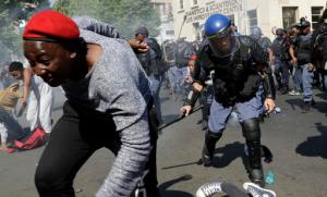 Students run for cover as police fire stun grenades and rubber bullets in an attempt to disperse them during their protest for free education in Johannesburg, South Africa, Wednesday, Sept. 21, 2016. A leading university in South Africa has closed for the rest of the week because of violence by protesters demanding free education across the country. (AP Photo/Themba Hadebe)