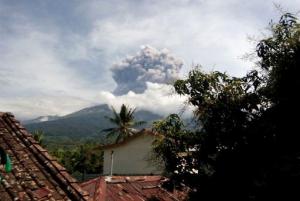 In this Tuesday, Sept. 27, 2016 photo, volcanic material from the eruption of Mount Barujari is seen from Bayan, Lombok Island, Indonesia. The volcano erupted without warning on Tuesday afternoon, delaying flights from airports on the islands of Lombok and Bali. (AP Photo/Denda Wiyana Putri)