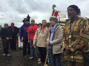 In this photo provided by LaDonna Allard, Green Party presidential candidate Jill Stein, second from right, participates in an oil pipeline protest, Tuesday, Sept. 6, 2016 in Morton County, N.D. North Dakota authorities plan to pursue charges against Green Party presidential candidate Jill Stein for spray-painting construction equipment at a Dakota Access Pipeline protest. Morton County Sheriff Kyle Kirchmeier said Tuesday that the charges would be for trespassing and vandalism. (LaDonna Allard via AP)