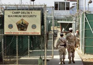FILE - In this June 27, 2006 file photo, reviewed by a Defense Department, U.S. military guards walk within Camp Delta military-run prison, at the Guantanamo Bay U.S. Naval Base, Cuba. A federal appeals court expressed concerns on Thursday, Sept. 8, 2016, about the prospect of ordering the Obama administration to release graphic videos of a former Guantanamo Bay inmate being force-fed during a hunger strike.  (AP Photo/Brennan Linsley, File)
