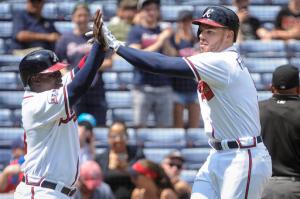 Atlanta Braves ' Freddie Freeman, right, celebrates his two-run home run at home plate with Adonis Garcia during the third inning of a baseball game against the San Diego Padres, Thursday, Sept. 1, 2016, in Atlanta. (AP Photo/John Amis)