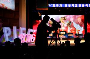 A North Korean television cameraman is silhouetted as he films at the Pyongyang International Film Festival on Friday, Sept. 23, 2016, in Pyongyang, North Korea. This year's Pyongyang International Film Festival wrapped up Friday with top honors going to a domestically produced feature about a young woman who devotes herself to raising orphans. (AP Photo/Wong Maye-E)