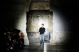 Anthony Vaccarello arrives on the catwalk at the end of Yves Saint Laurent Spring-Summer 2017 Ready-to-Wear fashion show, in Paris, Tuesday, Sept. 27, 2016. All eyes are on Anthony Vaccarello who launches his debut as designer for storied French house Saint Laurent as creative upheavals continue to impact Paris Fashion Week. (AP Photo/Francois Mori)