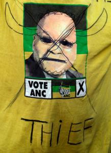 A supporter of the African National Congress, wearing a defaced t-shirt with president Jacob Zuma during their protest outside the ruling party ANC headquarters in downtown Johannesburg, South Africa, Monday, Sept. 5, 2016. A group of ANC members planning to occupy the organisation's headquarters' Luthuli House' on Monday' have reiterated their call that President Jacob Zuma resign and that the national executive committee resign. (AP Photo/Themba Hadebe)
