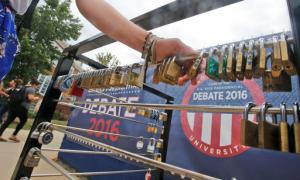 In this Wednesday, Sept. 7, 2016 photo, a Longwood University student grabs a few legacy locks at the school in Farmville, Va. The new tradition started last year allows seniors an alumni to decorate locks to keep their connection to the school. The school is hosting the lone vice-presidential debate on Oct. 4. (AP Photo/Steve Helber)