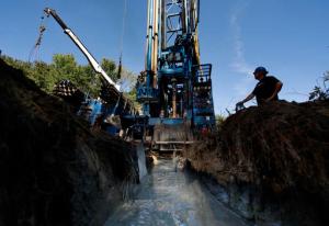 Josh Matthews keeps watch of the machinery as a well is drilled at a home, Thursday, Sept. 22, 2016, in Hampton Falls, N.H. Many private wells have gone dry amid this summer's prolonged drought and dry weather in the Northeastern U.S.(AP Photo/Robert F. Bukaty)