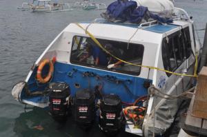 Police investigators examine the Gili Cat 2 boat following an explosion while it was enroute to nearby island of Lombok, at Padangbai Port in Karangasem, Bali, Indonesia, Thursday, Sept. 15, 2016.  Police on the Indonesian tourist island of Bali said Thursday a German woman was killed and about 20 other people injured in an explosion on a speed boat ferrying them to neighboring Lombok. (AP Photo)