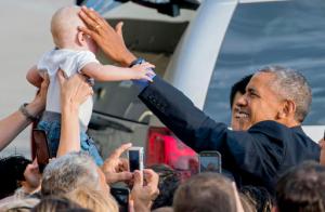 While greeting well wishers after arriving at John F. Kennedy International Airport in New York, President Barack Obama reaches out to Desmond Hatfield-Rudin, eight months old, of the Brooklyn borough of New York, Sunday, Sept. 18, 2016, in New York. (AP Photo/Craig Ruttle)