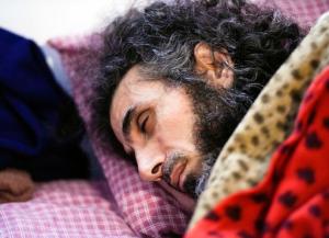 Syrian native Abu Wa'el Dhiab, a former Guantanamo detainee, rests in bed while conversing with his family via a laptop, in his apartment in Montevideo, Uruguay,Friday, Sept. 9, 2016. Activists and Uruguayan officials say the health of the former Guantanamo detainee resettled in the South American country is deteriorating as he continues a hunger strike at his home. Dhiab is demanding to leave Uruguay, which took him in with five other former Guantanamo prisoners in 2014. (AP Photo/Matilde Campodonico)
