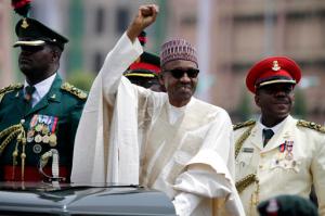 FILE - In this May 29, 2015 file photo, Nigeria President Muhammadu Buhari salutes his supporters during his inauguration in Abuja, Nigeria. Nigeria's President Muhammadu Buhari has apologized for plagiarizing President Barack Obama's 2008 victory speech and says he will punish those responsible. Adeola Akinremi in her Friday, Sept. 16, 2016 column for ThisDay newspaper denounced "the moral problem of plagiarism on a day Mr. President launched a campaign to demand honesty and integrity." (AP Photo/Sunday Alamba, File)