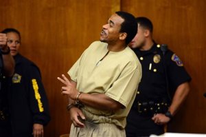 Charly Wingate arrives in court in Hackensack, NJ smiling and waving to his family Friday, Sept. 16, 2016.  The New York rap artist who was sentenced to 75 years in prison after a deadly robbery at a New Jersey hotel had his sentence cut by at least 55 years on Friday. Max B, whose real name is Charly Wingate, was re-sentenced by Bergen County Judge James Guida to 20 years after he pleaded guilty to aggravated manslaughter as part of a plea deal with prosecutors, attorney John Latoracca said.  (Tariq Zehawi/The Record of Bergen County via AP)