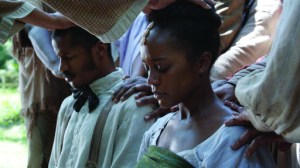 This image released by Fox Searchlight Pictures shows Nate Parker as Nat Turner, left, and Aja Naomi King as Cherry in a scene from, "The Birth of a Nation," in theaters on Oct. 7. (Fox Searchlight Pictures via AP)