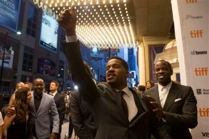 Director and actor Nate Parker, center, gestures to the crowd as he arrives on the red carpet for the film "Birth of a Nation" during the 2016 Toronto International Film Festival in Toronto on Friday, Sept. 9, 2016. (Chris Young/The Canadian Press via AP)