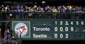 Fans lean on a concourse rail above the manual scoreboard at Safeco Field after the Toronto Blue Jays scored eight runs against the Seattle Mariners in the fourth inning of a baseball game, Tuesday, Sept. 20, 2016, in Seattle. (AP Photo/Ted S. Warren)