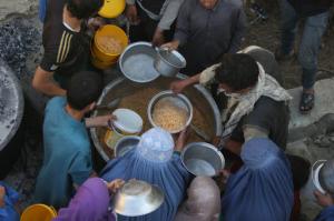 In this Thursday, June 9, 2016 photo, Afghan women and children receive free food donated by other villagers as they prepare to break their fast during the holy month of Ramadan in Kabul, Afghanistan. Fifteen years ago as the United States prepared to invade Taliban-ruled Afghanistan, then-First Lady Laura Bush took over her husband’s weekly radio address to tell the American people that part of the reason for going to war after the attacks of September 11, 2001, was to liberate Afghan women from the brutality of the extremists’ regime. But abuse of women in Afghanistan remains entrenched and endemic, despite constitutional guarantees of equality.(AP Photo/Rahmat Gul)