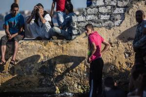 Egyptians wait as a coast guard boat arrives carrying the bodies of migrants from a Europe-bound boat that capsized off Egypt’s Mediterranean coast, in Rosetta, Egypt, Thursday, Sept. 22, 2016. According to the Egyptian health ministry, at least 50 bodies have been recovered so far from the early Wednesday disaster and up to a 100 more migrants remain unaccounted for in what could potentially rank among the deadliest incidents in the migrant route across the Mediterranean. Thousands of illegal migrants have made the dangerous sea voyage across the Mediterranean in recent years, fleeing war and poverty in the Middle East and elsewhere. (AP Photo/Eman Helal)