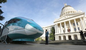 FILE - In this Feb. 26, 2015 file photo, a full-scale mock-up of a high-speed train is displayed at the Capitol in Sacramento, Calif. California Gov. Jerry Brown is making it a top priority to defeat a November proposition that would require a statewide vote before issuing bonds to fund mega-projects, such as the governor's proposed high-speed rail and Delta tunnels project. The California Democratic Party and Brown himself are taking part in the campaign to defeat Proposition 53. (AP Photo/Rich Pedroncelli, File)