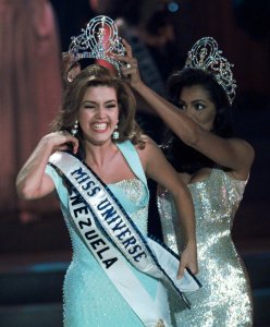 FILE - In this May 17, 1996, file photo, the new Miss Universe Alicia Machado of Venezuela reacts as she is crowned by the 1995 winner Chelsi Smith at the Miss Universe competition in Las Vegas. Machado became a topic of conversation during the first presidential debate between Republican nominee Donald Trump and Democratic candidate Hillary Clinton on Sept. 27, 2016. (AP Photo/Eric Draper, File)
