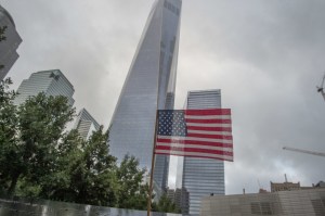 FILE - In this Sept. 11, 2015 file photo, a flag is placed along the South Pool prior to a ceremony at the World Trade Center site in New York. Neither of the two New Yorkers vying for the White House is expected to commemorate the 15th anniversary of the Sept. 11th terror attacks with a visit to Ground Zero. Hillary Clinton and Donald Trump are not slated to attend the annual commemoration at the former World Trade Center site, a spokesman for the memorial told The Associated Press on Tuesday, Sept. 6, 2015. (AP Photo/Bryan R. Smith, File)