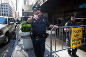 New York City police officers move journalists and pedestrians away from Trump Tower during a meeting between Israeli Prime Minister Benjamin Netanyahu and Republican presidential candidate Donald Trump, Sunday, Sept. 25, 2016, in New York. (AP Photo/ Evan Vucci)