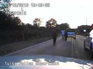 In this image made from a Friday, Sept. 16, 2016 police video, Terence Crutcher, center, is pursued by police officers as he walk to an SUV in Tulsa, Okla. Crutcher was taken to the hospital where he was pronounced dead after he was shot by the officer around 8 p.m., Friday, police said. Crutcher had no weapon on him or in his SUV, Tulsa Police Chief Chuck Jordan said Monday, Sept. 19, 2016. (Tulsa Police Department via AP)