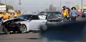 In this Thursday, Aug. 25, 2016 photo, Oregon State Police investigate a fatal car crash at Highway 99 North and Clear Lake Road in Eugene, Authorities say Steven and Skinner, of Harrisburg, Ore., died in the three-vehicle crash that left two other people injured. (Andy Nelson/The Register-Guard via AP)