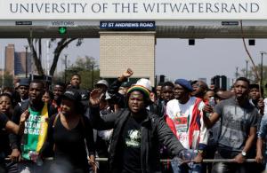 University students protest for free education at the entrance of the University of the Witwatersrand in Johannesburg, South Africa, Tuesday, Sept. 20, 2016. South African university students who want free education are protesting on several campuses, and police have arrested at least 10 students who blocked an entrance at the University of the Witwatersrand in Johannesburg. (AP Photo/Themba Hadebe)