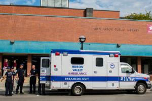 In this September 9, 2014 file photo, Ann Arbor police, firemen, and medical personnel respond to an overdose at the Ann Arbor District Library in Ann Arbor, Mich.  Librarians are finding themselves face-to-face with the heroin and opiod epidemic as drug users take advantage of the free access to quiet areas where people often keep to themselves.(Katie McLean, The Ann Arbor News via AP)