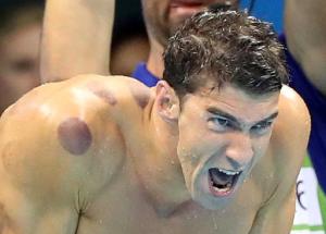 FILE - In this Aug. 7, 2016, file photo United States swimmer Michael Phelps encourages his teammates in the final of the men's 4x100-meter freestyle relay during the swimming competitions at the 2016 Summer Olympics in Rio de Janeiro, Brazil. Phelps recreated an angry face he was caught making by TV cameras ahead of one race at the Games for host Jimmy Fallon during an appearance on NBC's "Tonight Show" Thursday, Sept. 1, 2016. (AP Photo/Lee Jin-man, File)