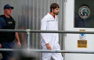 Nathan Carman, right, disembarks at the US Coast Guard station in Boston, Tuesday, Sept. 27, 2016. Carman spent a week at sea in a life raft before being rescued by a passing freighter. (AP Photo/Michael Dwyer)
