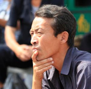 A North Korean man watches a news report regarding a nuclear test on a large screen outside the Pyongyang Station in Pyongyang, North Korea, Friday, Sept. 9, 2016. North Korea said Friday it conducted a "higher level" nuclear warhead test explosion, which it trumpeted as finally allowing it to build "at will" an array of stronger, smaller and lighter nuclear weapons. (AP Photo/Jon Chol Jin)